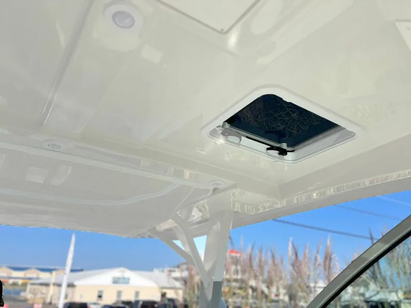Slide: The Image of 2025 Sailfish 316 DC boat interior roof with open hatch and clear sky view. - 19