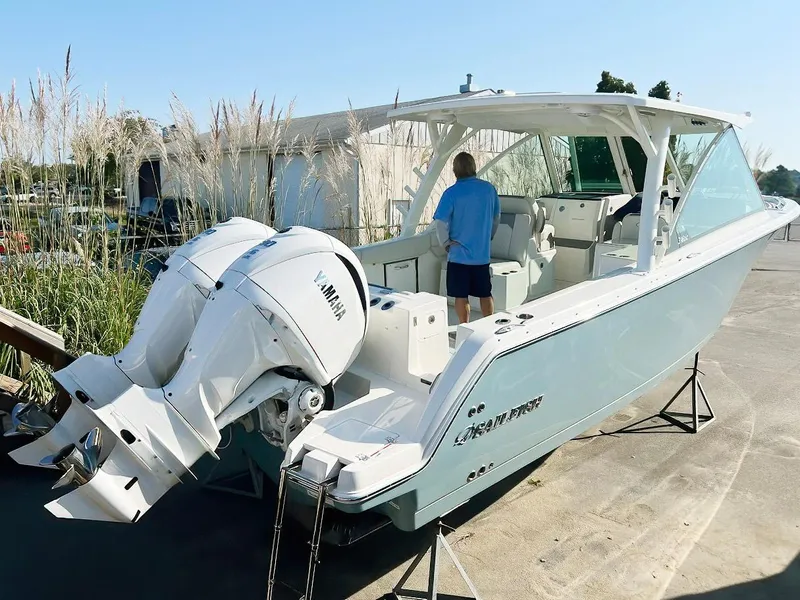 Slide: The Image of 2025 Sailfish 316 DC boat with Yamaha engines, docked outdoors. - 2