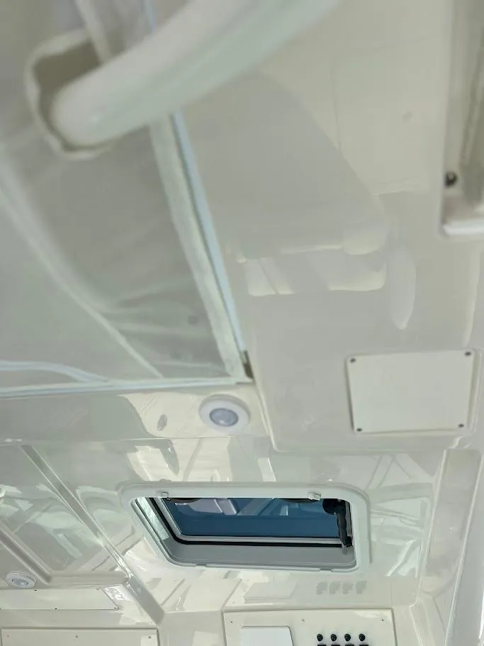Slide: The Image of Interior view of 2025 Sailfish 316 DC boat ceiling with hatch and lighting. - 20