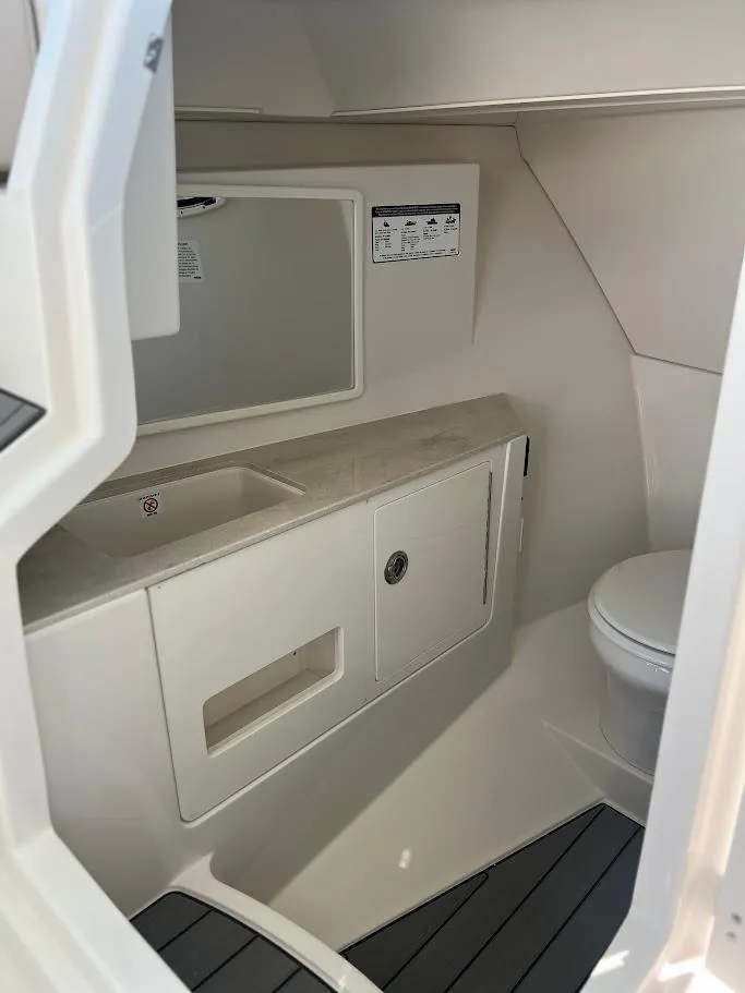 Slide: The Image of 2025 Sailfish 316 DC boat interior bathroom with sink and toilet. - 21