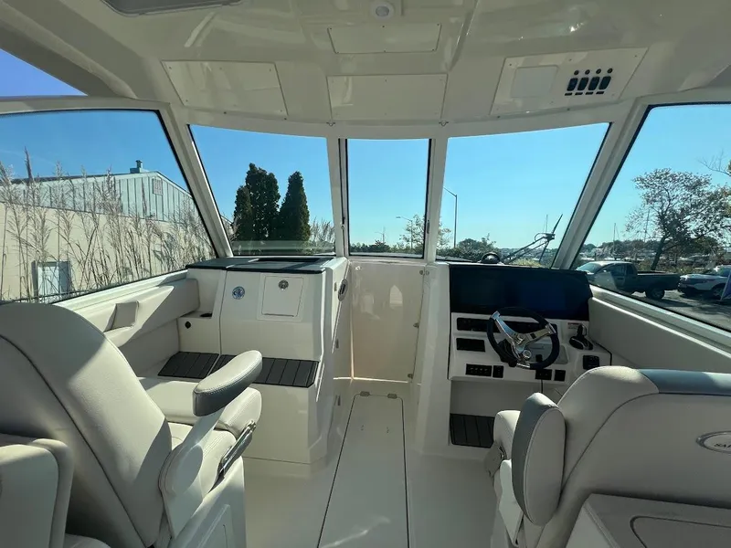 Slide: The Image of Interior of 2025 Sailfish 316 DC boat, featuring modern helm and seating. - 22