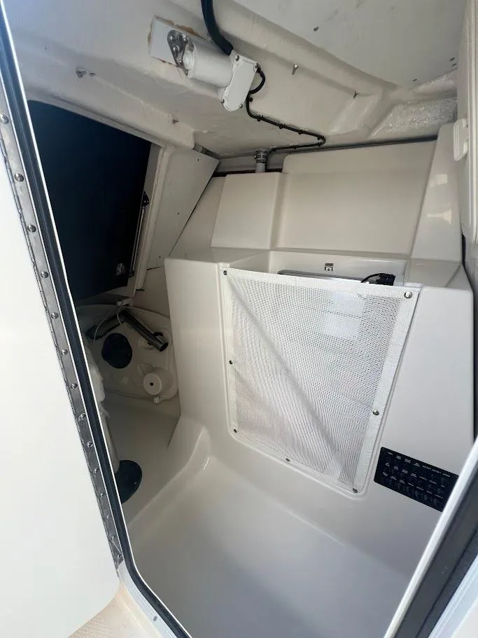 Slide: The Image of Interior cabin of 2025 Sailfish 316 DC boat, featuring storage and clean design. - 23