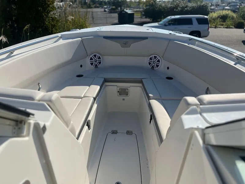 Slide: The Image of 2025 Sailfish 316 DC boat interior with cushioned seating and speakers. - 24