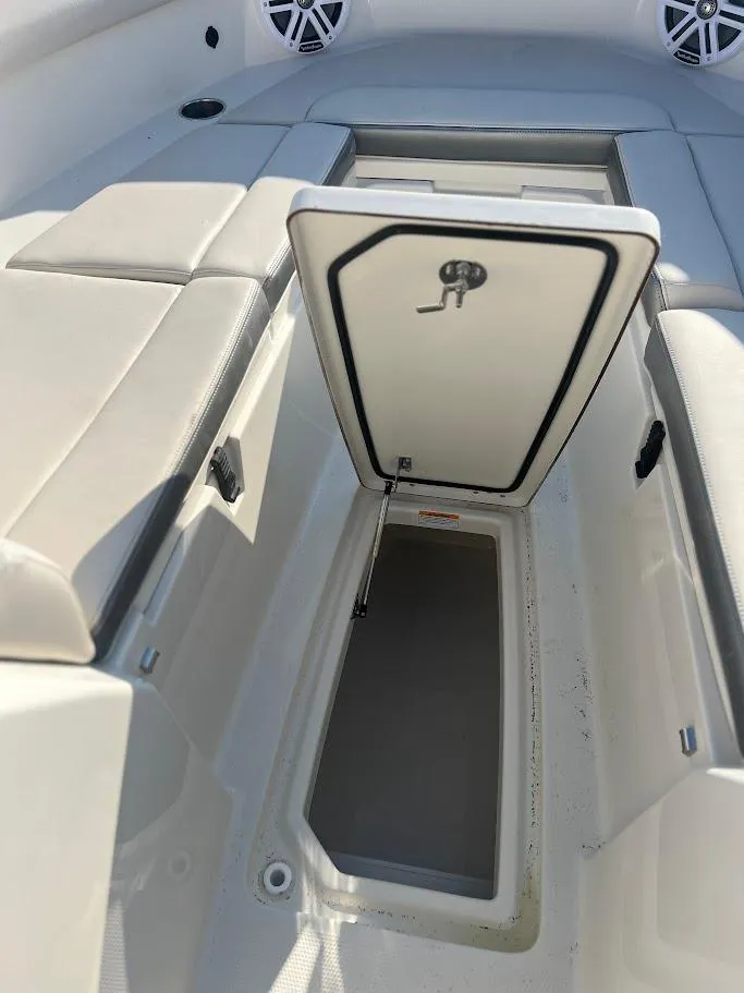 Slide: The Image of 2025 Sailfish 316 DC boat storage compartment with open hatch, showcasing interior space. - 28