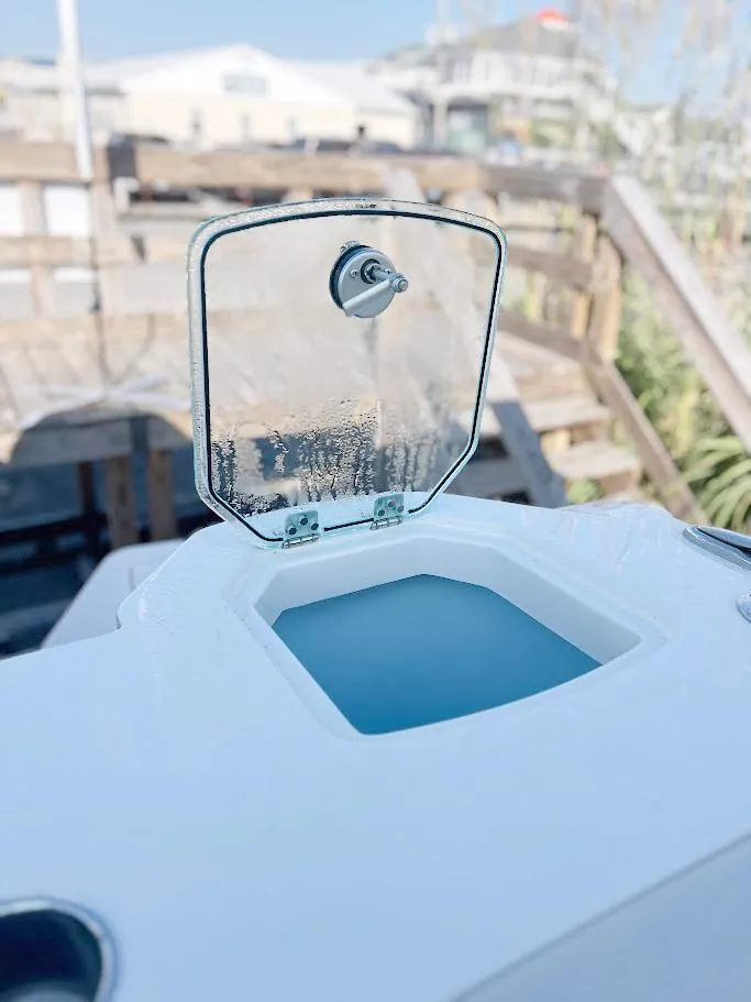 Slide: The Image of Open hatch on 2025 Sailfish 316 DC boat, revealing storage compartment. - 3