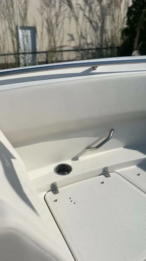 Slide: The Image of 2025 Sailfish 316 DC boat interior with sleek white seating and stainless steel fixtures. - 32