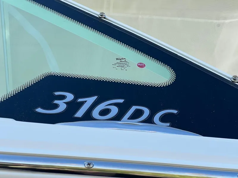 Slide: The Image of Sailfish 316 DC boat model, 2025, close-up view of windshield and logo. - 34