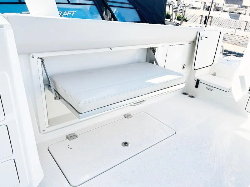 Slide: The Image of 2025 Sailfish 316 DC boat interior with foldable seat and storage compartments. - 4