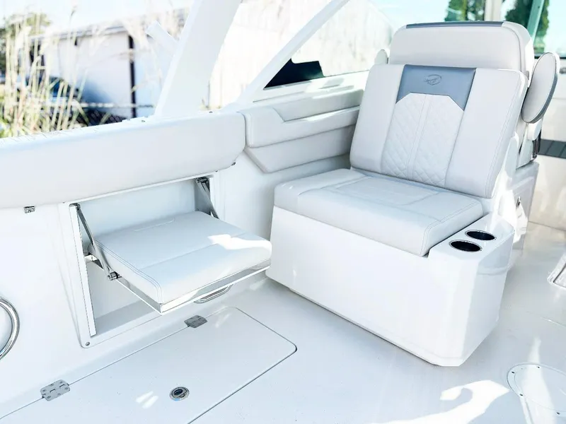 Slide: The Image of 2025 Sailfish 316 DC boat interior with white seating and cup holders. - 5