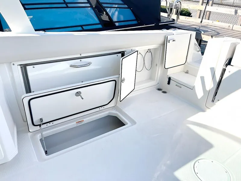 Slide: The Image of 2025 Sailfish 316 DC boat interior with open storage compartments and sleek design. - 7