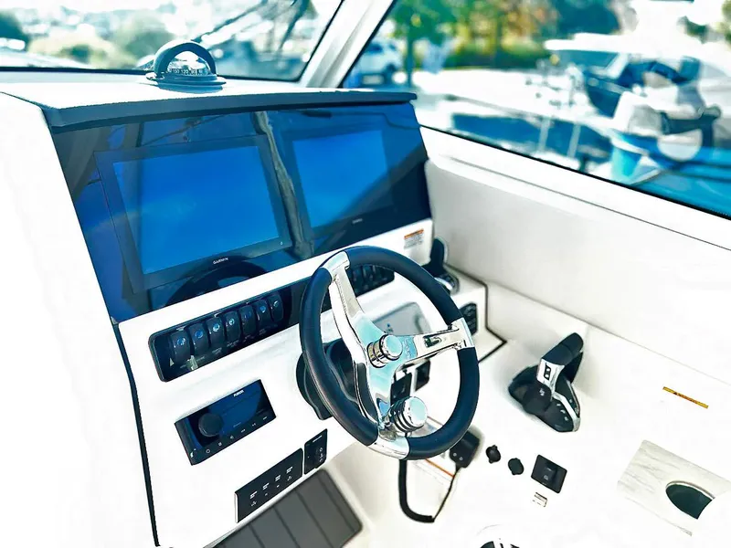 Slide: The Image of Helm of 2025 Sailfish 316 DC boat with dual screens and modern controls. - 9