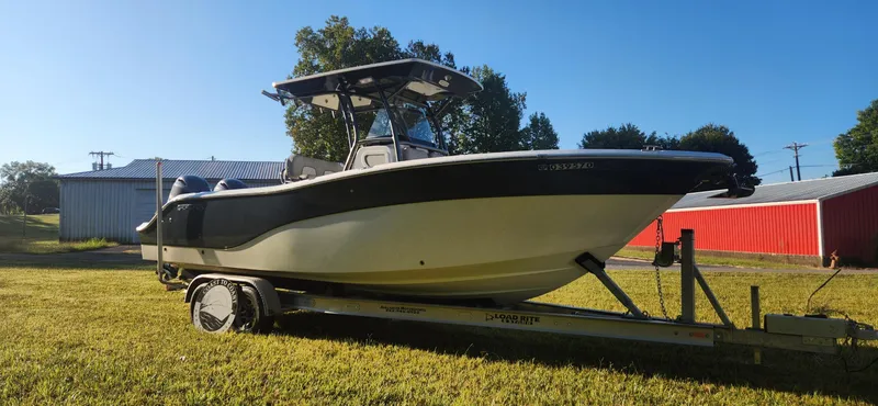 Slide: The Image of 2019 Sea Fox 266 Commander boat on trailer, parked on grass, sunny day. - 1