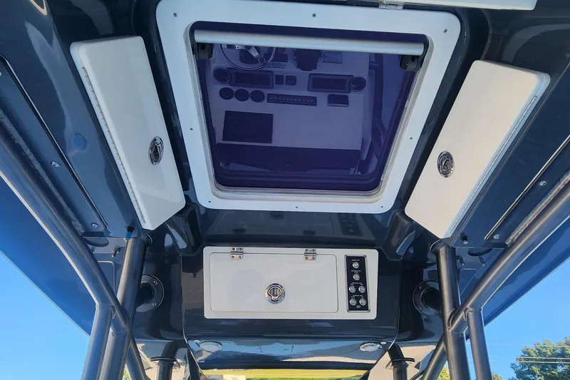 Slide: The Image of 2019 Sea Fox 266 Commander boat console and overhead storage compartments. - 10