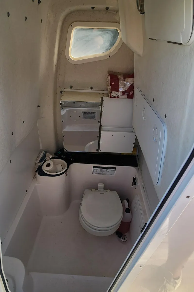 Slide: The Image of 2019 Sea Fox 266 Commander boat interior with compact marine toilet and storage. - 13