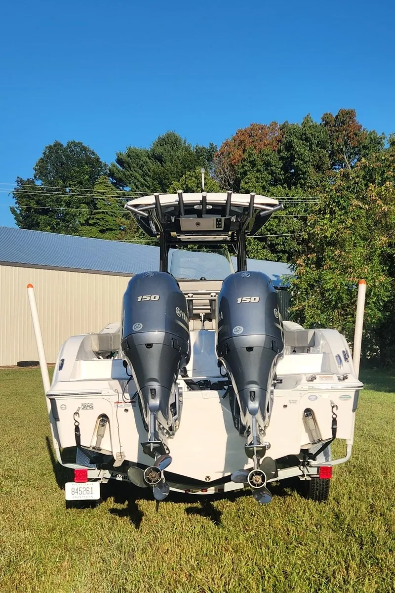 Slide: The Image of 2019 Sea Fox 266 Commander boat with dual engines, parked on grass. - 2