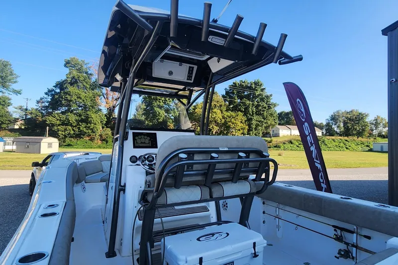 Slide: The Image of 2019 Sea Fox 266 Commander boat interior with seating and console, outdoors on a sunny day. - 3