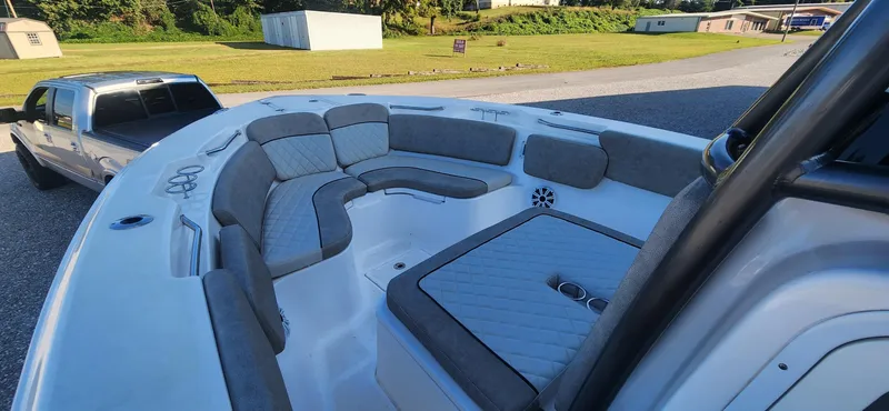 Slide: The Image of 2019 Sea Fox 266 Commander boat with spacious seating, parked near a pickup truck. - 7