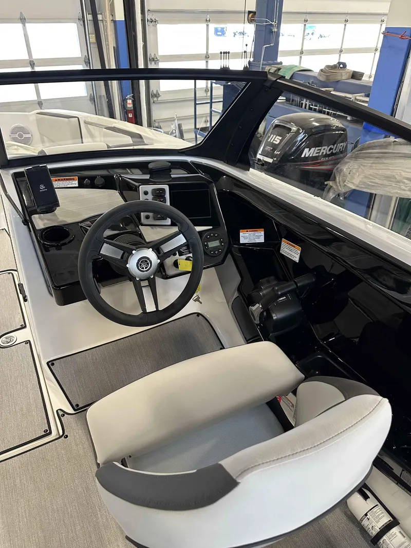 Slide: The Image of 2025 Yamaha Boats AR220 cockpit with steering wheel and control panel. - 6