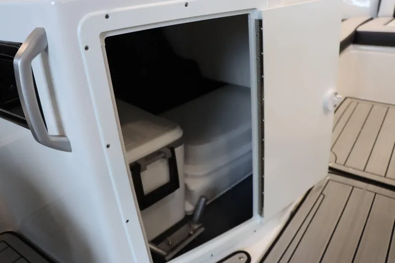 Slide: The Image of Open storage compartment on 2025 Yamaha Boats 195S, featuring sleek interior design. - 16