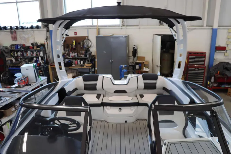 Slide: The Image of 2025 Yamaha Boats 195S interior with sleek seating and modern design in a workshop setting. - 20