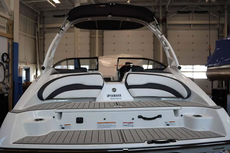 Slide: The Image of 2025 Yamaha Boats 195S, rear view in a showroom setting. - 5