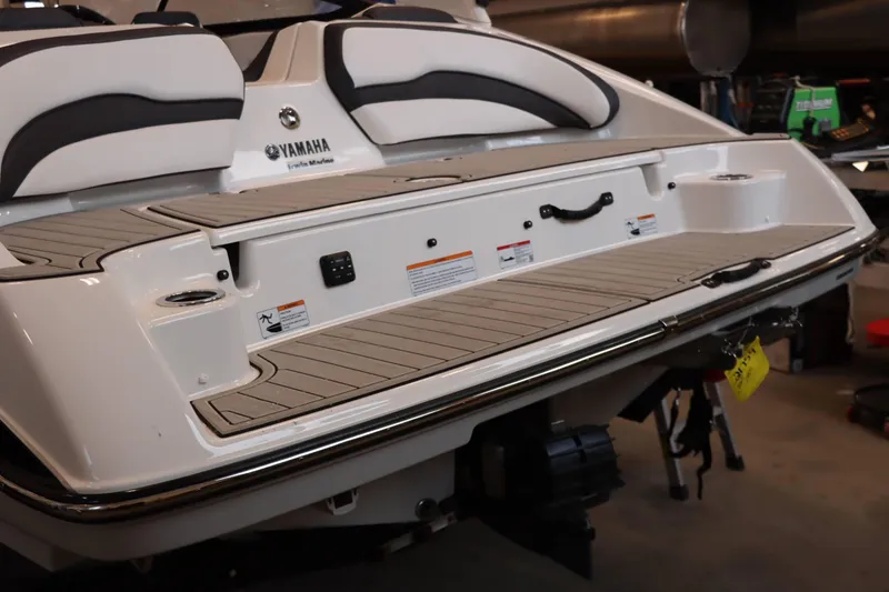 Slide: The Image of 2025 Yamaha Boats 195S rear view, showcasing sleek design and spacious deck. - 6
