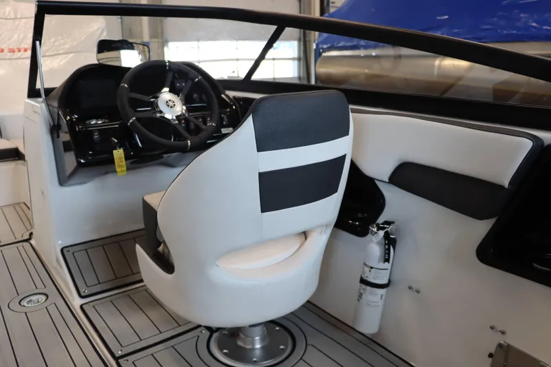 Slide: The Image of 2025 Yamaha Boats 195S interior with steering wheel and captain's chair. - 11