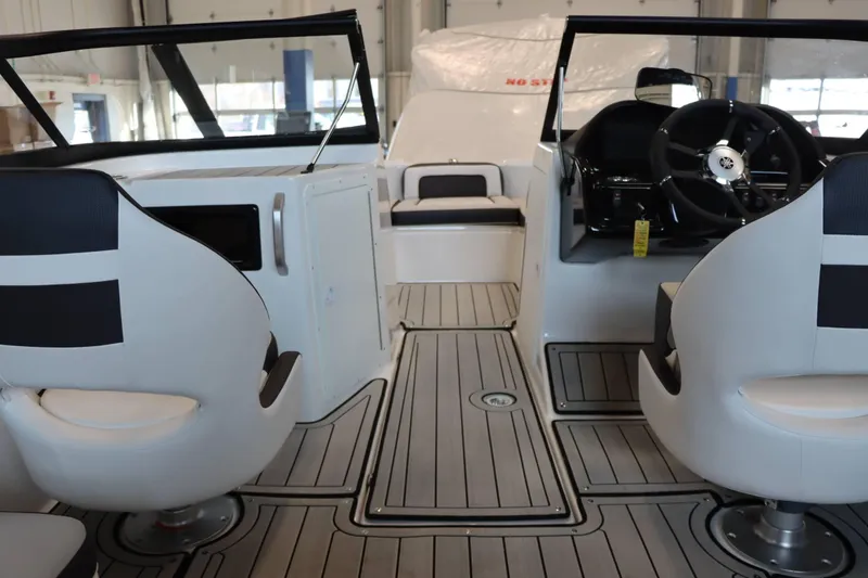Slide: The Image of Interior of 2025 Yamaha Boats 195S, featuring sleek seating and modern dashboard design. - 13