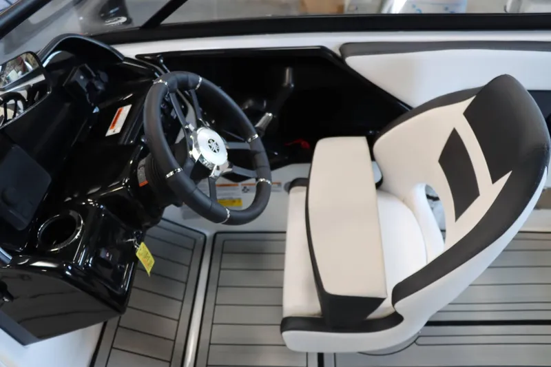 Slide: The Image of 2025 Yamaha Boats 195S cockpit with sleek steering wheel and modern seating design. - 15