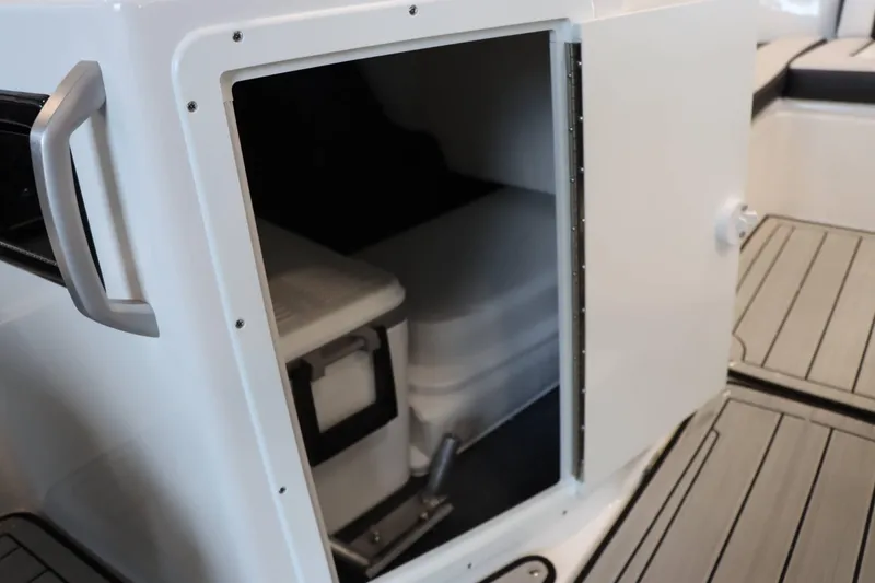 Slide: The Image of 2025 Yamaha Boats 195S storage compartment with open door, revealing interior space. - 17