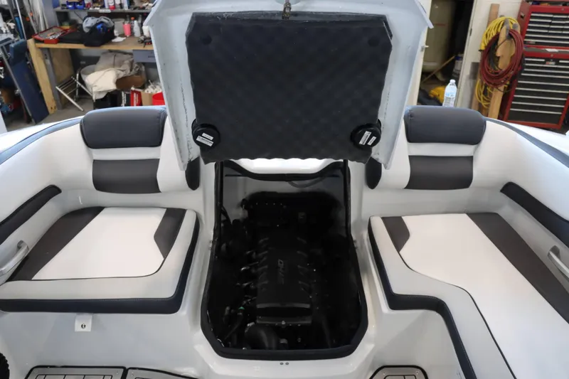 Slide: The Image of 2025 Yamaha Boats 195S engine compartment with open hatch, showcasing interior seating. - 26