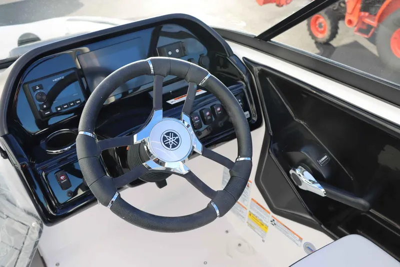 Slide: The Image of 2025 Yamaha Boats 195S steering wheel and dashboard close-up. - 13