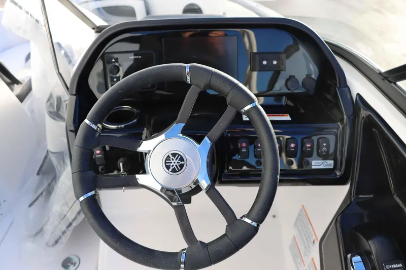 Slide: The Image of 2025 Yamaha Boats 195S steering wheel and dashboard controls. - 14