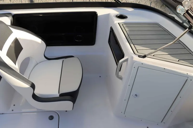 Slide: The Image of 2025 Yamaha Boats 195S interior with white seating and storage compartment. - 18