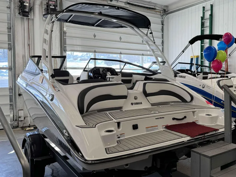 Slide: The Image of 2025 Yamaha Boats 195S in showroom, featuring sleek design and modern interior. - 21