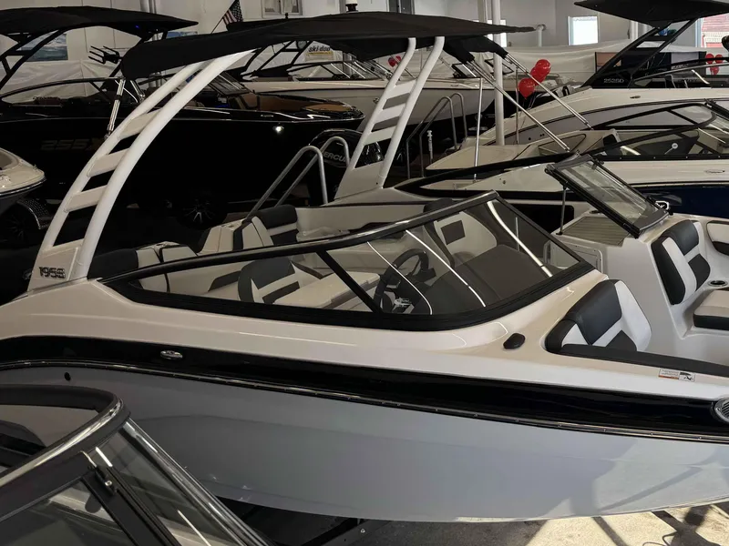 Slide: The Image of 2025 Yamaha Boats 195S in showroom, sleek design with modern features. - 23