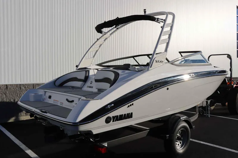 Slide: The Image of 2025 Yamaha Boats 195S, sleek white design, parked on trailer. - 3