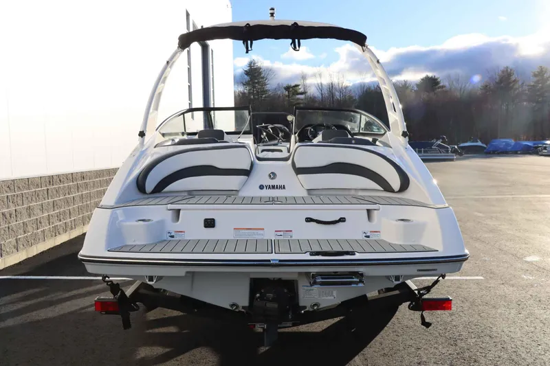Slide: The Image of 2025 Yamaha Boats 195S, rear view, parked outdoors on a sunny day. - 4