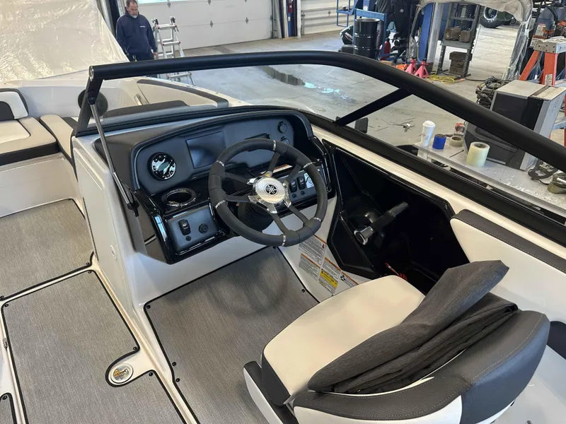 Slide: The Image of 2025 Yamaha Boats SX195 interior with steering wheel and dashboard in a workshop setting. - 5