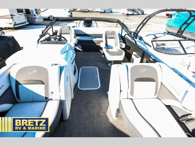 Slide: The Image of Interior of 2023 CORSA 23UC boat with seating, steering wheel, and Bretz RV & Marine logo. - 13