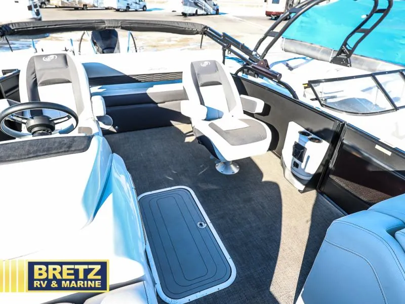 Slide: The Image of Interior of 2023 CORSA 23UC boat with seating and steering wheel, Bretz RV & Marine logo. - 16