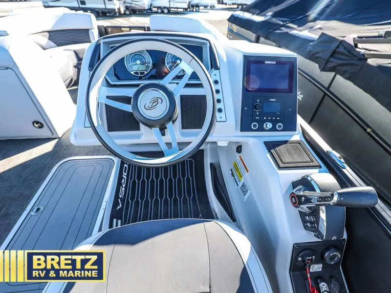 Slide: The Image of 2023 CORSA 23UC boat dashboard with steering wheel and control panel at Bretz RV & Marine. - 18