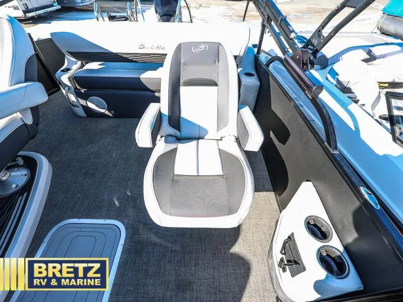Slide: The Image of 2023 CORSA 23UC boat interior with seating and cup holders, Bretz RV & Marine branding. - 19