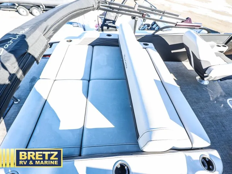 Slide: The Image of 2023 CORSA 23UC boat interior with cushioned seating, Bretz RV & Marine branding. - 23