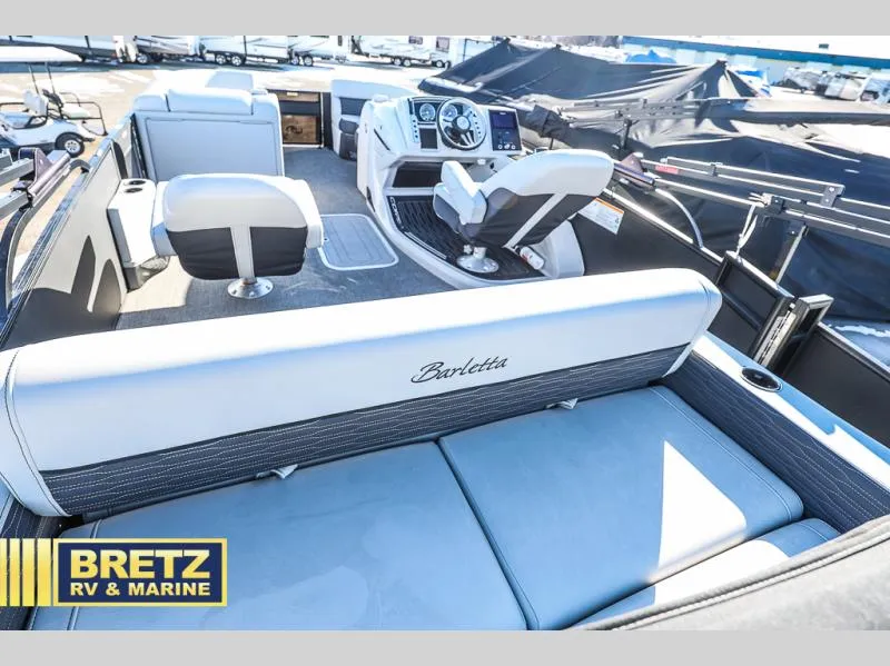 Slide: The Image of Interior of a 2023 CORSA 23UC boat with seating and control panel. - 24