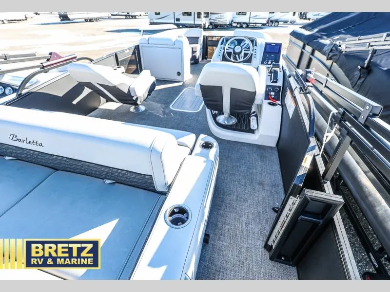 Slide: The Image of Interior of a 2023 CORSA 23UC boat with seating and steering console. - 26