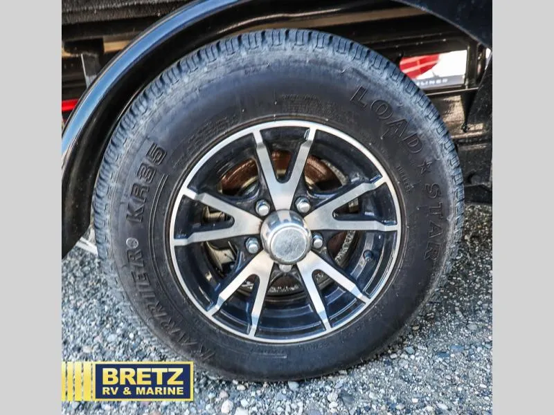 Slide: The Image of Close-up of a 2023 CORSA 23UC wheel with Load Star tire on gravel. - 33