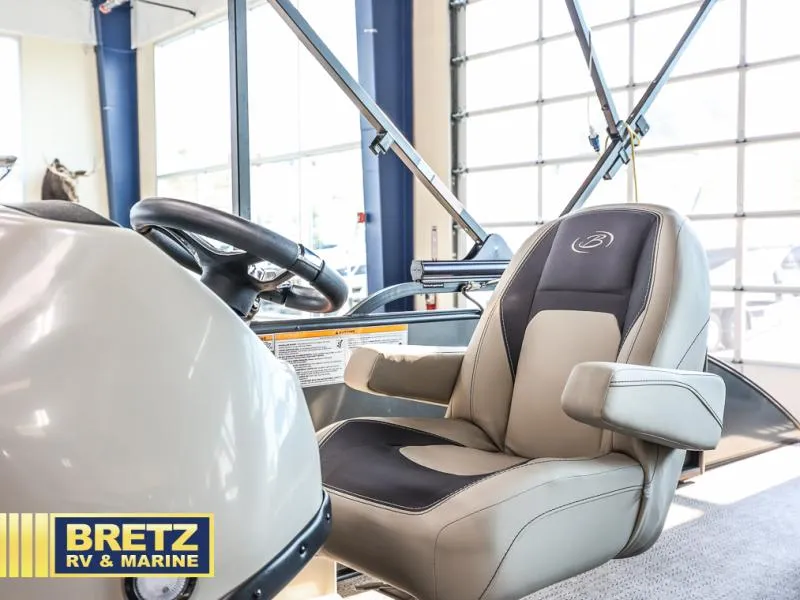 Slide: The Image of Aria Ultra-Lounge A24UC 2024 boat interior with steering wheel and comfortable seating. - 10