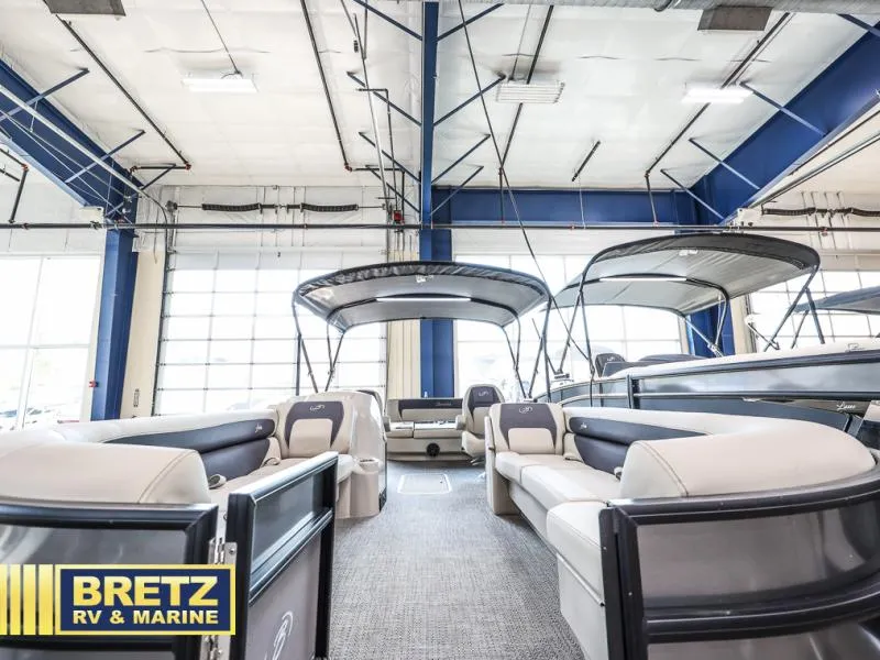 Slide: The Image of 2024 Aria Ultra-Lounge A24UC pontoon boat displayed at Bretz RV & Marine showroom. - 3