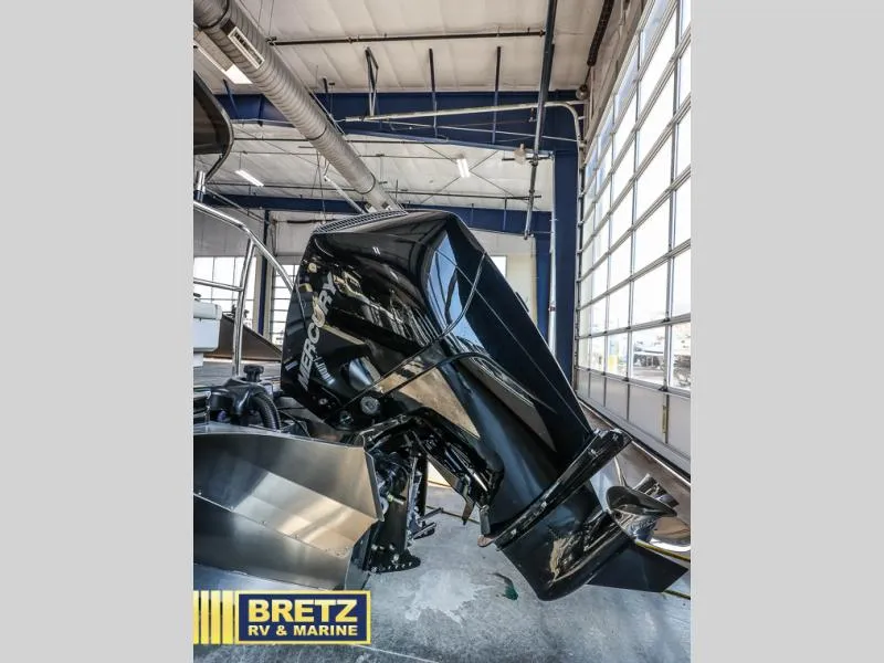 Slide: The Image of 2024 Aria Ultra-Lounge A24UC with Mercury outboard motor in showroom. - 7